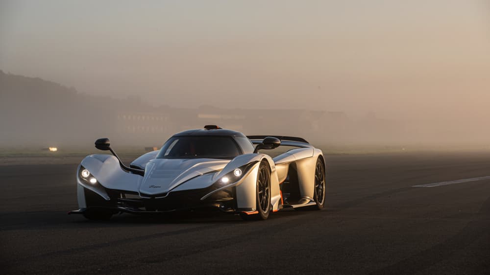 Angled view of a silver Bohema on the racing track with a misty background