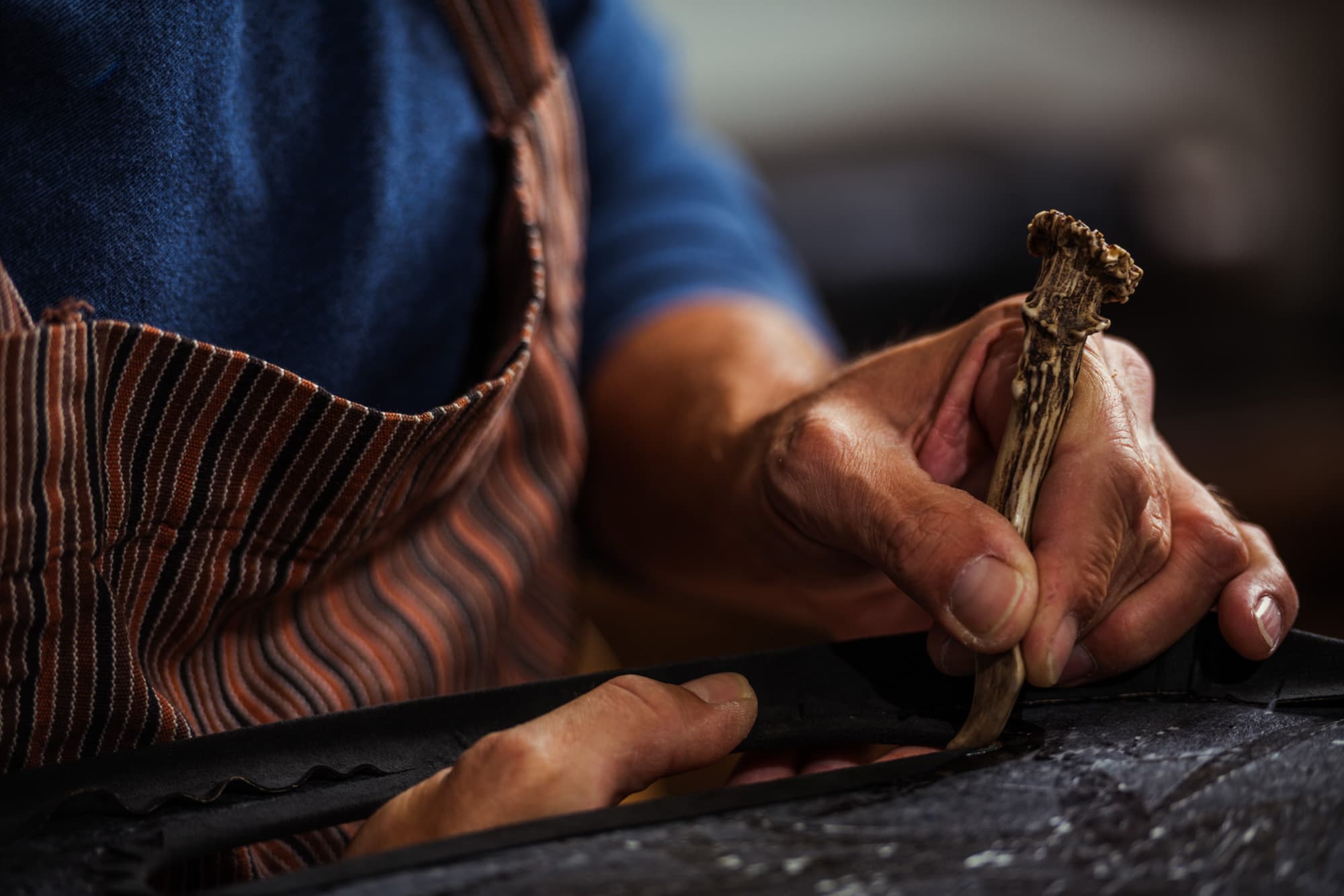 Leather being smoothened by hand